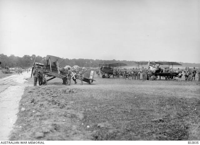 Aeroplanes from an Australian Flying Squadron which flew over to attend the 4th Australian Divisional race meeting. SE5A serial E5965 "X" 1/4f.p with another SE5A and a Camel in the background.